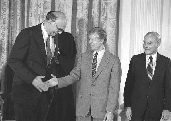 Mr. Volcker at his swearing-in in August 1979, with President Jimmy Carter and Treasury Secretary G. William Miller. His harsh anti-inflation policies contributed to Mr. Carters defeat by Ronald Reagan the next year.