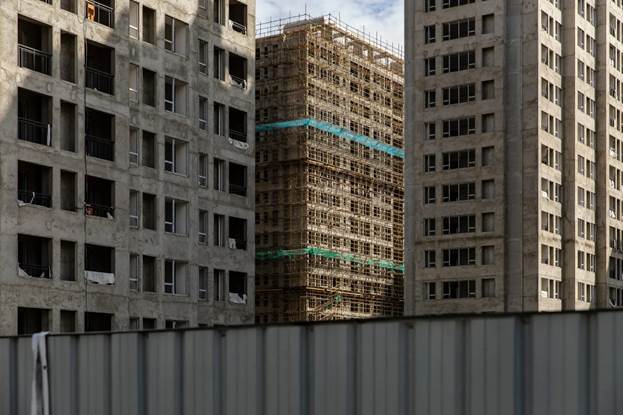 A building under construction in a city

Description automatically generated