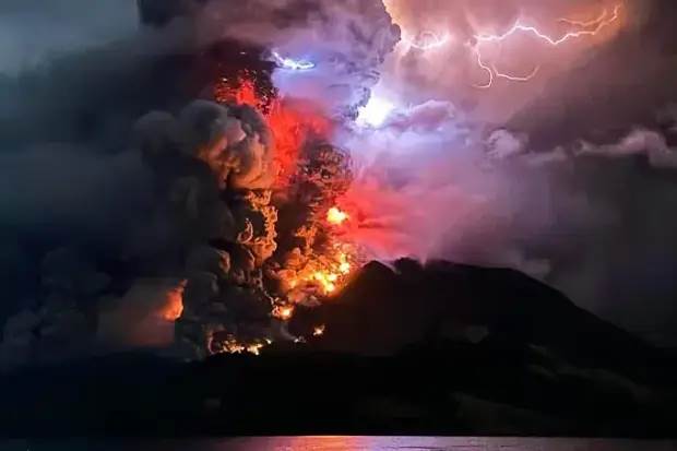 A volcano erupting with lightning and clouds

Description automatically generated